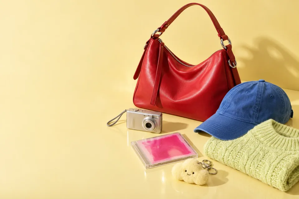 A red bag, blue cap and small Korean finds on a sunny yellow set